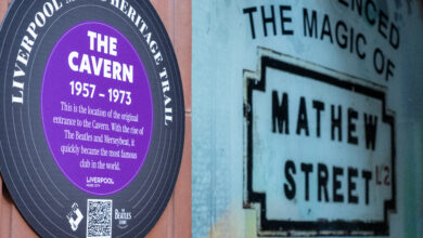 Liverpool Music Heritage Trail Launches As Beatles Legacy Group Marks 10 Years 1 A man hangs a plaque on the wall outside of Liverpool's Cavern