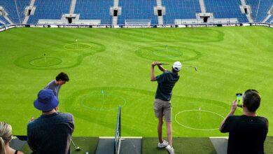 A person playing golf at Hill Dickson Football Stadium