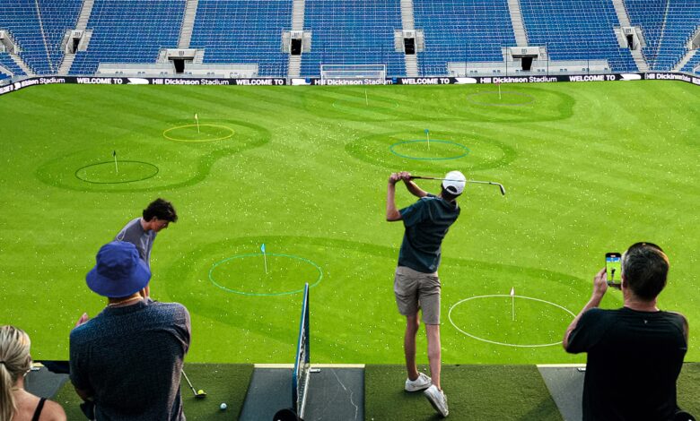 Tee Off Inside Everton's Hill Dickinson Stadium This Summer 1 A person playing golf at Hill Dickson Football Stadium