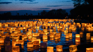 Paper lanterns lit up gloating on the water at night